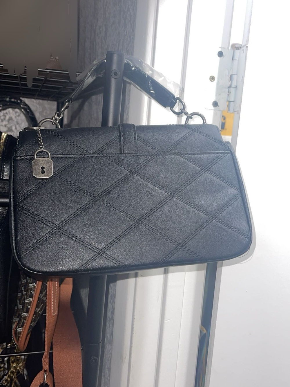 Quilted Black Shoulder Bag with Top Handle and Padlock Charm